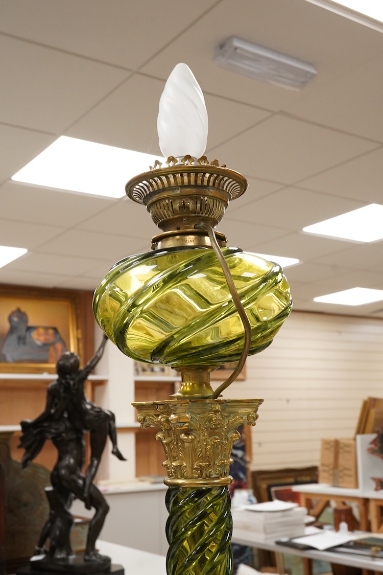 A 19th century gilt and brass green glass corinthian columned oil lamp by Messenger, 68cm high